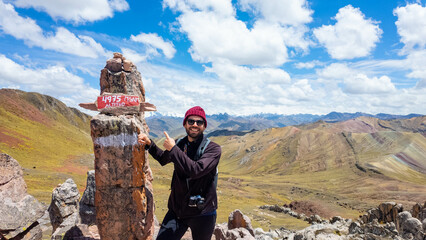 Young traveler on the peak of a mountain in Andes range in Peru