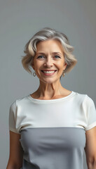 Fototapeta premium Positive Beautiful Middle Aged Female Posing Over Light Grey Background, hyperrealism, with white tones