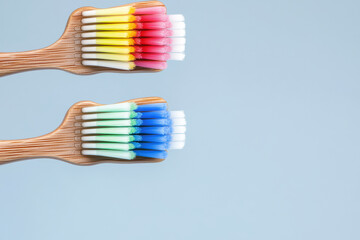 Eco friendly bamboo toothbrushes with colorful bristles on blue background. Perfect for promoting sustainable oral care