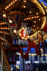The Whimsical Carousel at Night is Beautifully Illuminated by Bright Festive Lights and Colors