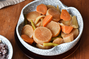 Simmered vegetables, including radish, carrot, onion, and green beans, cooked in a light soy-based broth. A classic Japanese nimono dish served in a patterned bowl, warm and comforting.