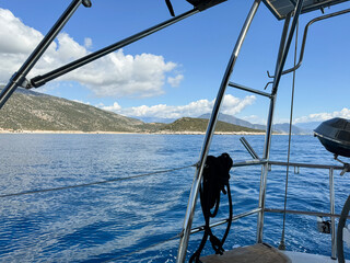 Scenic boat view of a serene coastline on a sunny day with clear blue skies