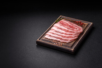 Fresh raw bacon sliced with spices and herbs