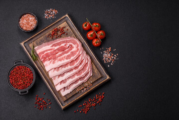 Fresh raw bacon sliced with spices and herbs