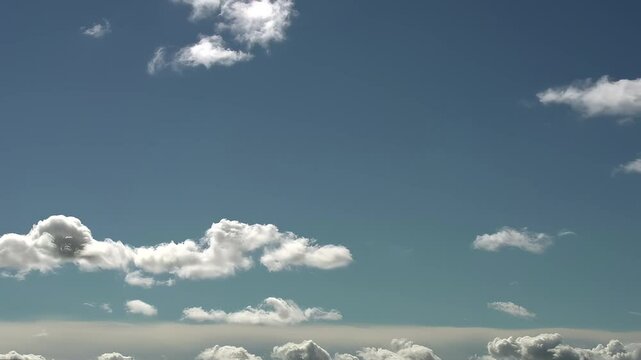 Flow of Clouds in the Blue Sky. Majestic clouds illuminated by the sun. Timelipse
