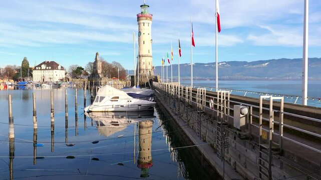Harbor of Lindau on lake Constance with lighthouse and lion statue on a sunny day in winter, Germany, Bavaria