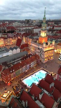 aerial flyover of poznan city center in winter in poland with christmas decorations