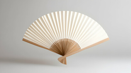 Elegant wooden hand fan with a minimalist design on a white isolated background.