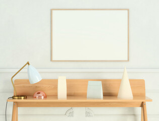 Mock up poster frame on white plaster wall with lamp, cone and geometric objects on wooden writing desk; landscape orientation; stylish frame mock up; 3d rendering, 3d illustration	