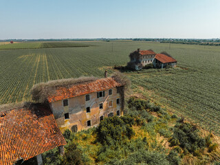 Italy - Abandoned houses near Jesolo from drone view. You can see how growing uon the nature on the human creations
