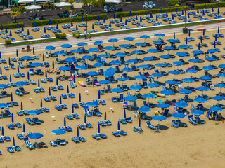 Fototapeta premium Italy, Jesolo near Bibione. Lido di Jesolo, or Jesolo Lido, is the beach area of the city of Jesolo in the province of Venice, Aerial View with sandy beach and with an endless parasols