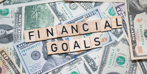 Financial Goals Text Overlaid on Background of U.S. Dollars - Achieving Economic Success