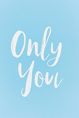 Fototapeta premium Inspirational text artwork featuring the phrase Only You on a light blue background to encourage self-love and individuality