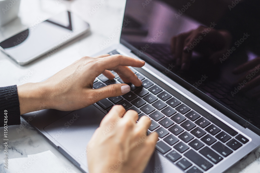 Poster a woman's hands typing on a sleek laptop keyboard, with the office environment appearing hazy in the