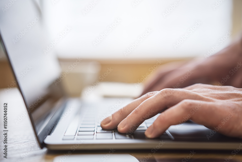 Poster set against a blurry office backdrop, the image captures a man's hands in close detail, typing on a 