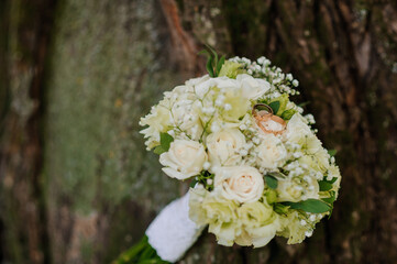 Wedding Bouquet with Engagement Rings Set Against Nature's Backdrop