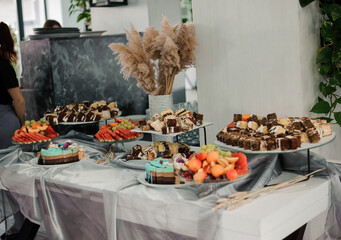 Elegant Dessert Display Featuring Assorted Cakes, Fruits, and Decorative Elements