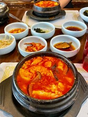 spicy Korean tofu stew with little bowls of ban chan