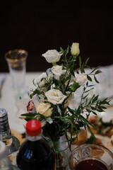 Elegant Table Centerpiece with White Roses and Refreshing Beverages