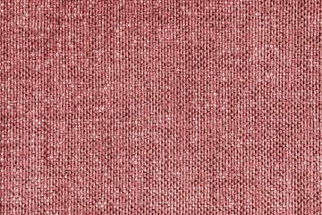 Upholstery red colored jacquard fabric coarse weave texture close up, macro. Textile background, furniture textile material, wallpaper, backdrop. Cloth structure close up, macro