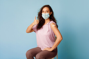 Covid-19 Vaccination. Vaccinated Woman Gesturing Thumbs Up Showing Arm With Plaster Bandage After...