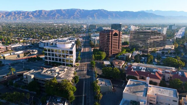 Aerial view of a vibrant city with majestic mountains behind
