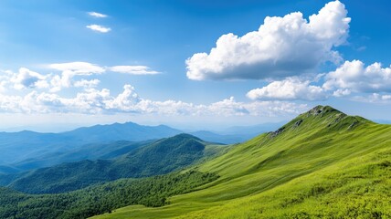 Fototapeta premium Serene green mountain landscape with blue sky and clouds