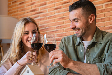 Couple Toasting with Red Wine Indoors