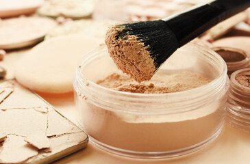Brush with beauty cosmetics background, varieties of face powders and foundations for perfect complexion, basic make up products to even out and matte skin, selective focus, shallow DOF