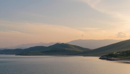 Fototapeta premium a body of water of a lake between mountains