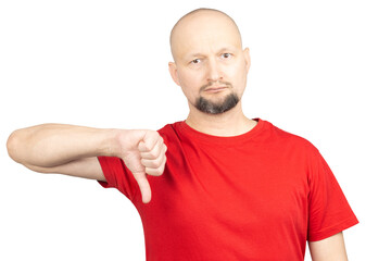 A man wearing a red T-shirt is posing with a thumbs-down gesture, expressing disapproval or...