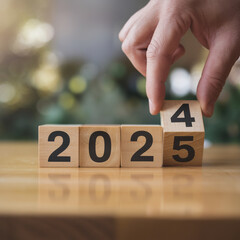 Hand Flipping Block to Change Year to 2025
