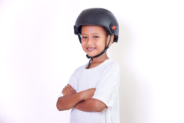 A young asian boy smiles confidently while wearing a helmet and a white shirt.