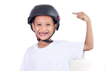 A confident asian boy wearing a helmet, pointing to his helmet with a big smile.