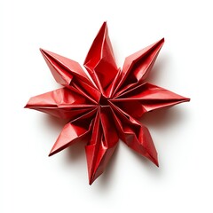 Fototapeta premium A vibrant red origami star expertly crafted from folded paper, showcasing intricate design and texture against a clean white background.