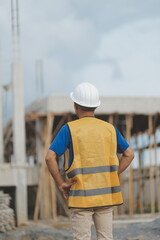 Asian man architect holds blueprint with skyscraper background, Asian male architect builder...