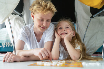 Portrait of Brother and Sister Playing Together Under Table