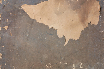 damaged or weathered paper background texture, brownish tone grunge ripped or peeling revealing lighter layer underneath surface, backdrop or wallpaper for designing