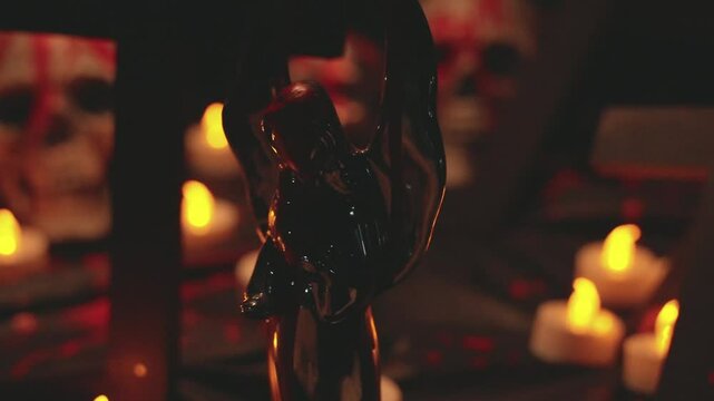 Pan shot of halloween decorations, including skulls, candles, angels and cross with fake blood smeared around