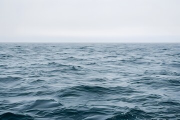 Open sea with gentle waves under a clear sky, offering a peaceful and tranquil ocean view.