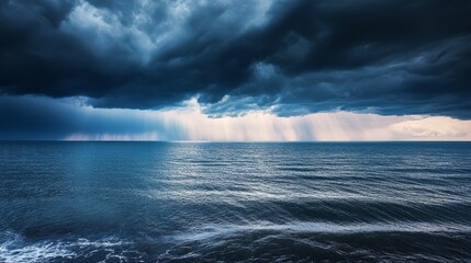 A dramatic seascape with dark clouds and rays of light piercing through the stormy sky.