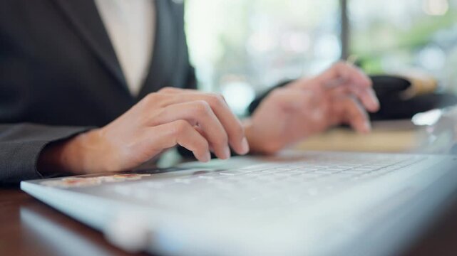 A person is typing on a laptop keyboard. Concept of productivity and focus, as the person is likely working on a task or project. The laptop itself is a modern and sleek device
