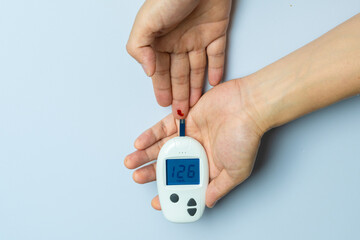 Generated imageTitle Woman's hands checking diabetes and hyperglycemia with digital blood sugar meter. Healthcare and medical concept	