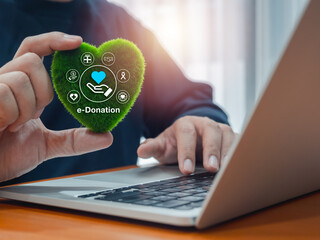 Donation online concept. Text Donate with charity and fundraising icons, graphics on green grass...