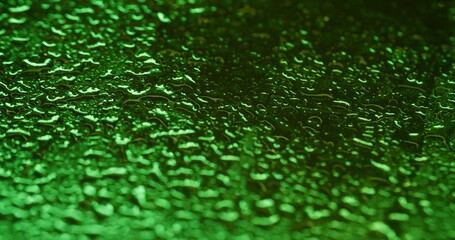 Glass bubble. Rain drops. Sparkling colorful green bright fluid water gleaming blinking liquid on abstract bokeh light art background.