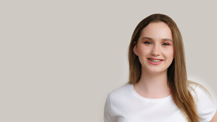 Teeth treatment. Healthy smile. Closeup of satisfied cheerful teen girl posing with metal braces...