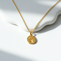 Fototapeta premium gold chain necklace with oval pendant on white background