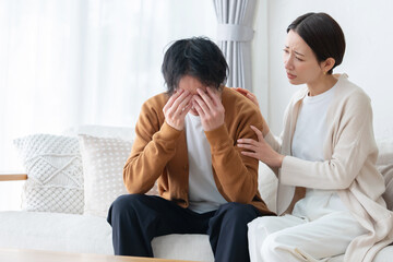 頭痛・悩む・落ち込む男性・心配する女性