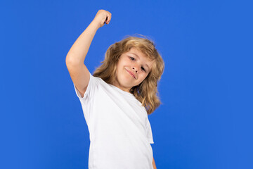 Fototapeta premium Excited kid on studio isolated background. Surprised face, amazed emotions of child. Excited kid boy celebrating victory on studio isolated background. Rejoicing, yes gesture and success concept.