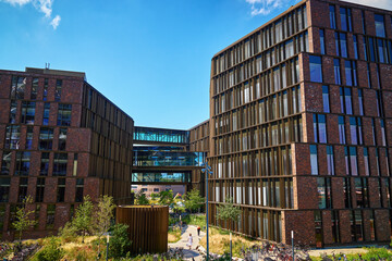 Residential district in Copenhagen, Denmark. Modern city architecture with eco friendly buildings. Urban setting with contemporary office buildings and walking people